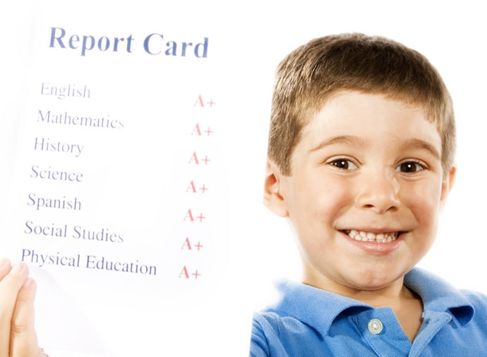 Child holding up A+ report card - About us